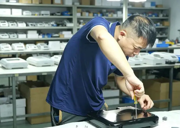 Technician assembling a plastic prototype for product validation.