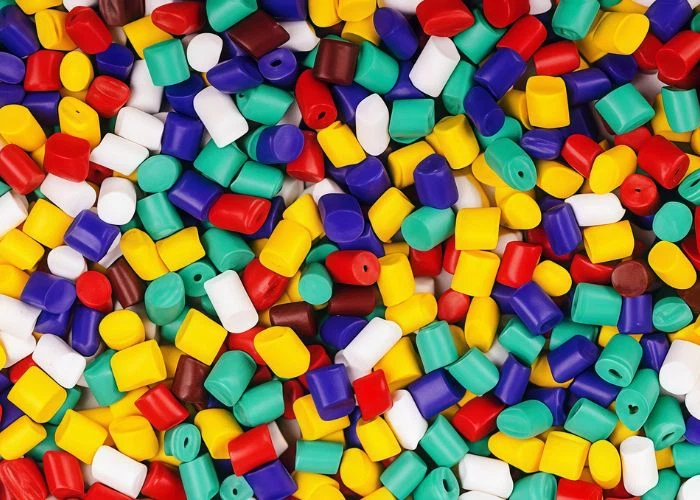 Pile of colorful plastic pellets stacked display, raw plastic material sample